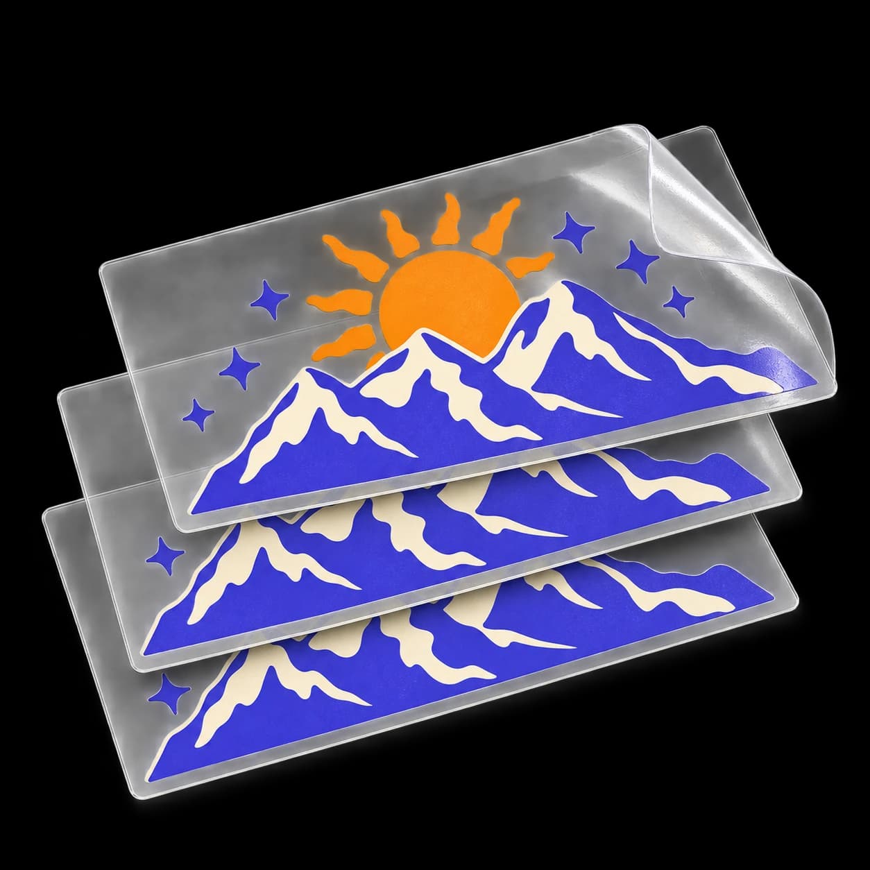 Orange sun and purple mountain UV DTF designs aligned on clear transfer sheets